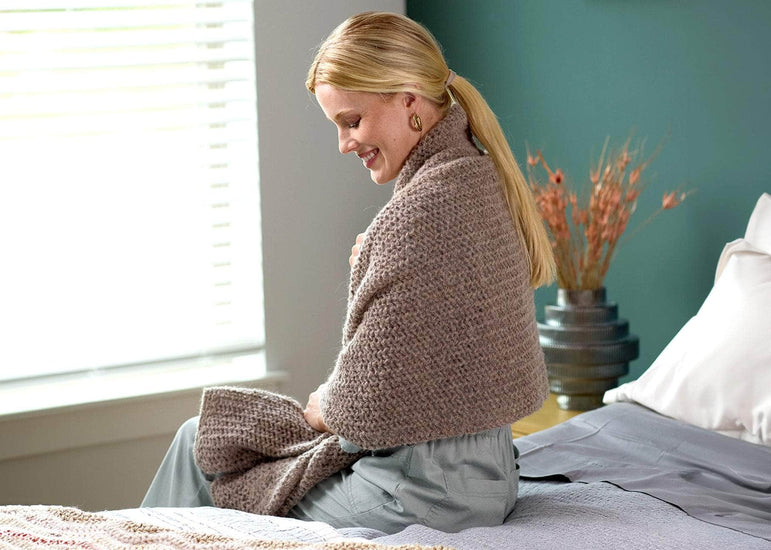 A strong independent woman enjoying her brand new painted room while enjoying her brand new knitted stole created with elle by me.