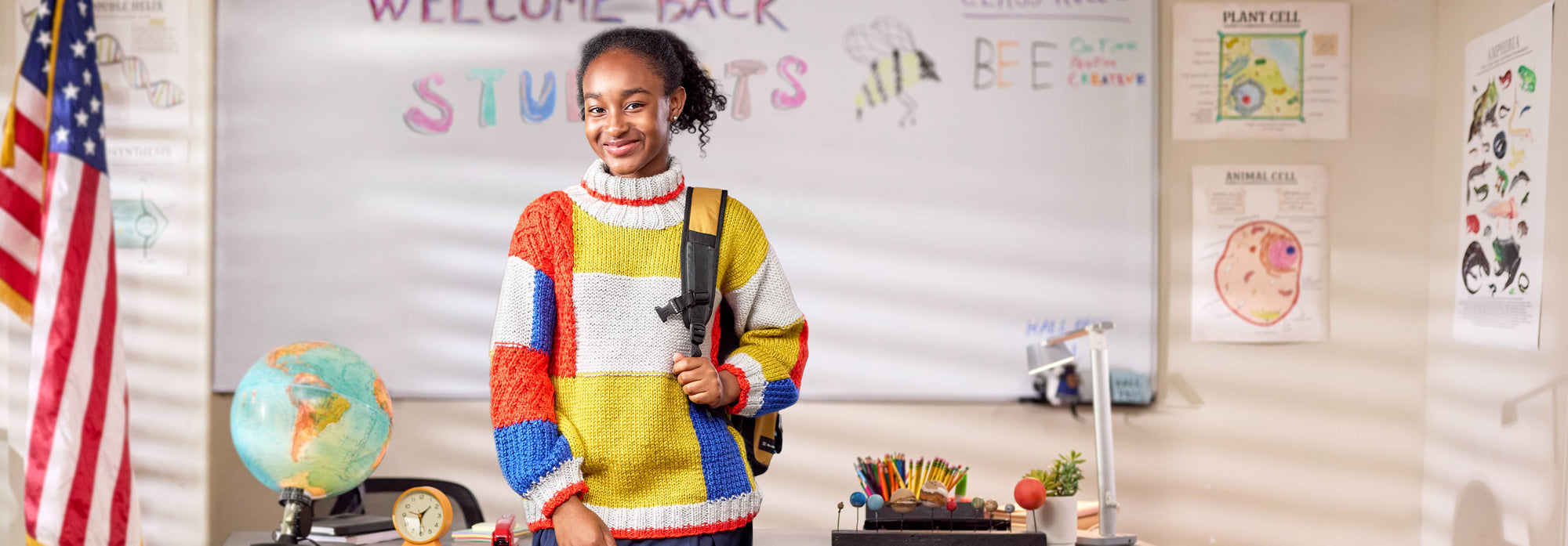 Student in a classroom wearing a handmade knit colorblock patchwork pullover pattern